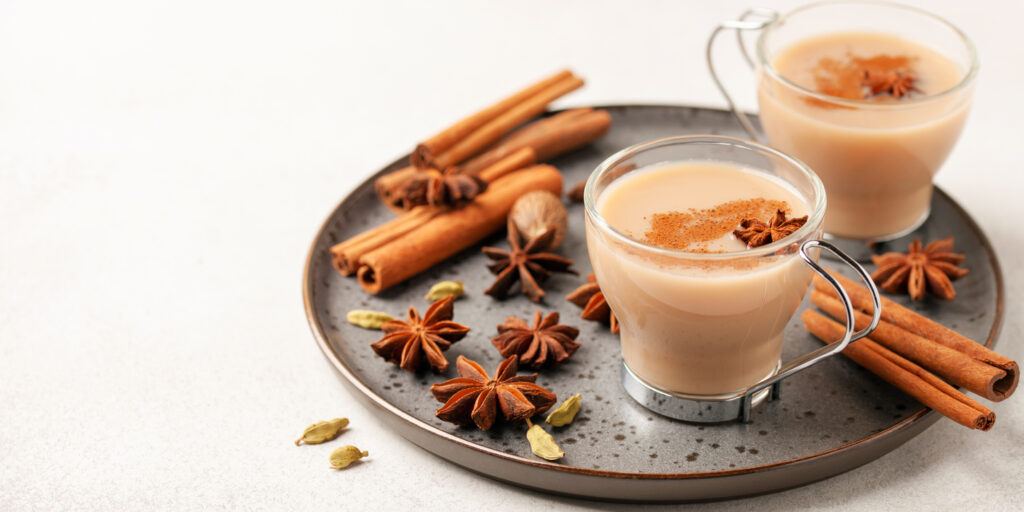 Masala tea in a glass cup with cardamom, star anise and cinnamon. Antiviral drink for immunity.